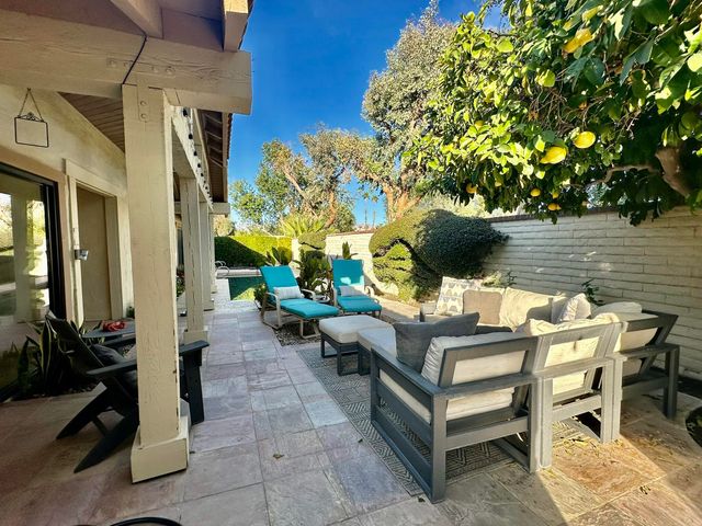 a view of a patio with table and chairs and potted plants
