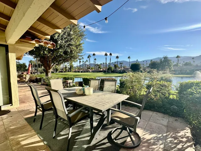 a view of a chairs and table in the patio
