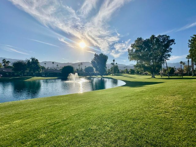 a view of a lake with houses in the background