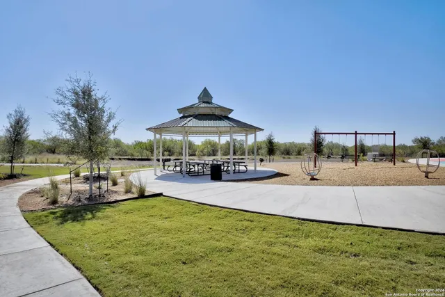 an outdoor space with swimming pool and furniture