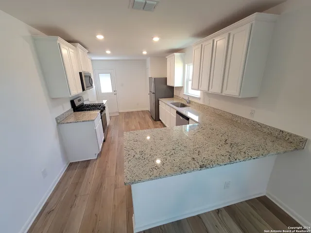 a kitchen with sink and cabinets