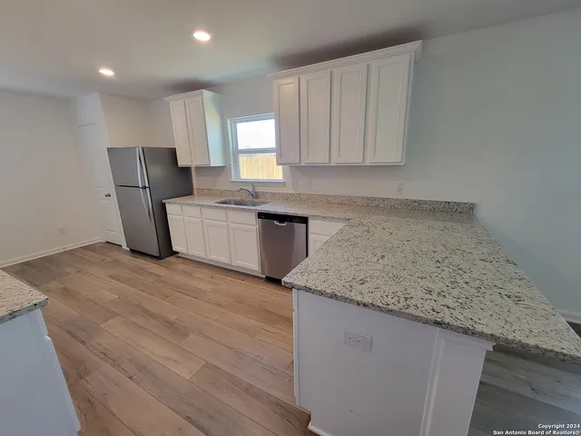 a kitchen with a sink stove and cabinets