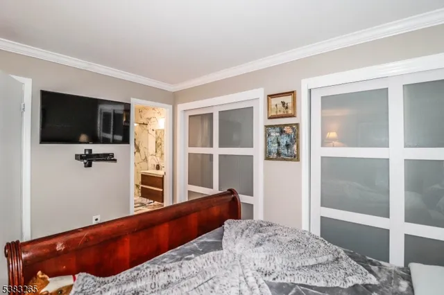 a bedroom with a bed and flat screen tv