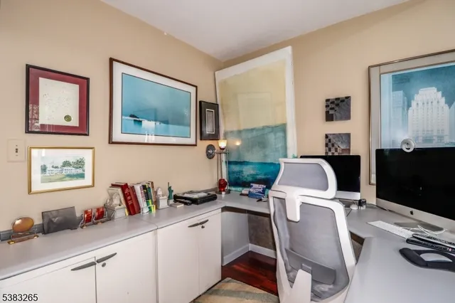 a work place that has a couch and a computer on a desk