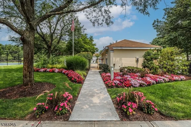a view of a garden with flowers and trees