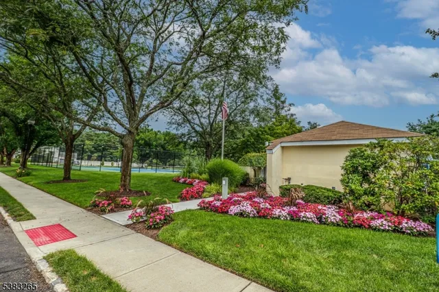 a front view of a house with a yard and fountain