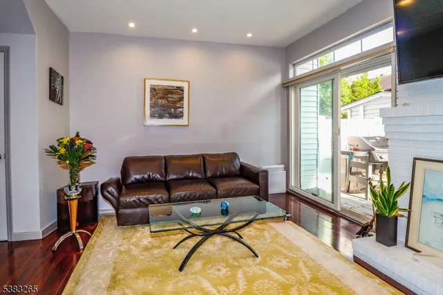 a living room with furniture potted plant and a large window