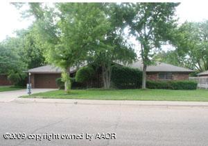 6706 Jameson Road Amarillo, TX 79106 - Photo 1 of 13 a front view of a house with a yard and trees