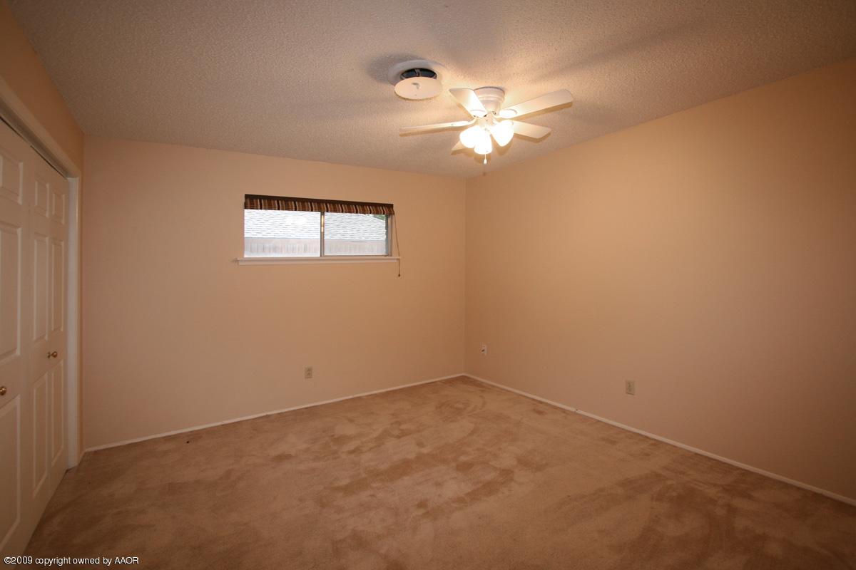 6706 Jameson Road Amarillo, TX 79106 - Photo 4 of 13 a view of an empty room with a window