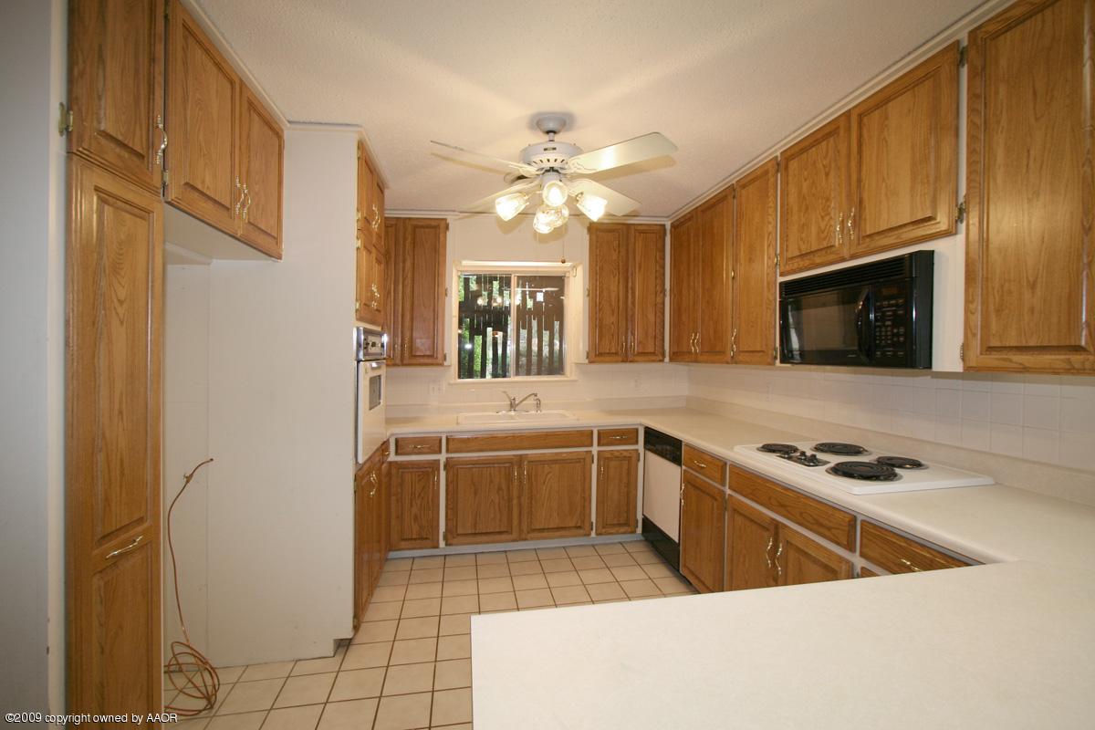 6706 Jameson Road Amarillo, TX 79106 - Photo 9 of 13 a kitchen with a sink appliances and cabinets