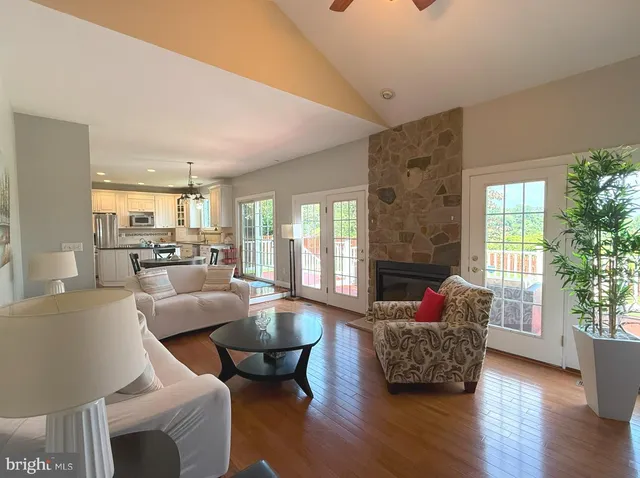 a living room with furniture wooden floor and a fireplace