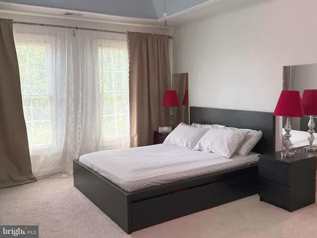 a bedroom with a bed and a lamp