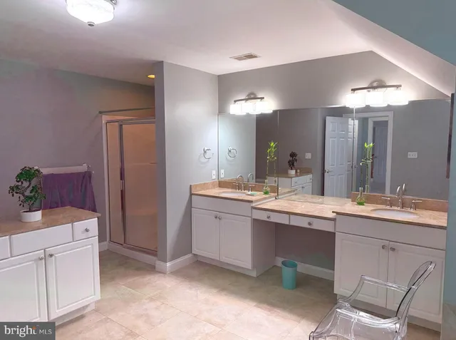 a large bathroom with a sink and a mirror