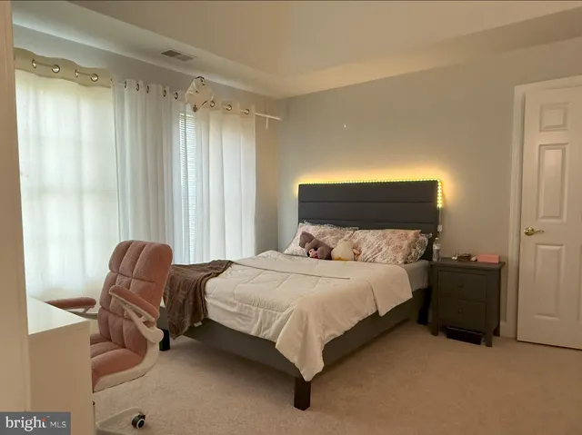 a bedroom with a bed and chair