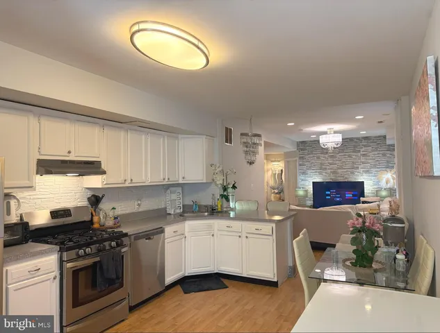 a kitchen with a sink cabinets and stainless steel appliances
