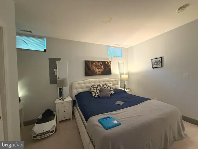 a living room with a couch and a potted plant