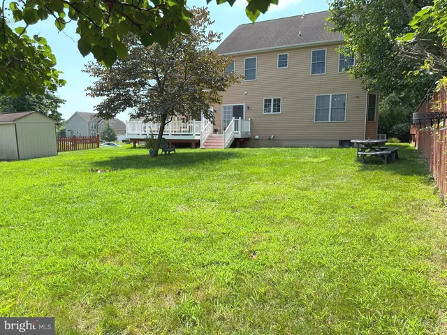 a view of backyard of house with green space