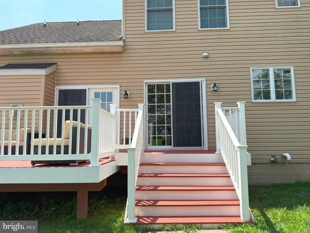 a view of a deck with a white house
