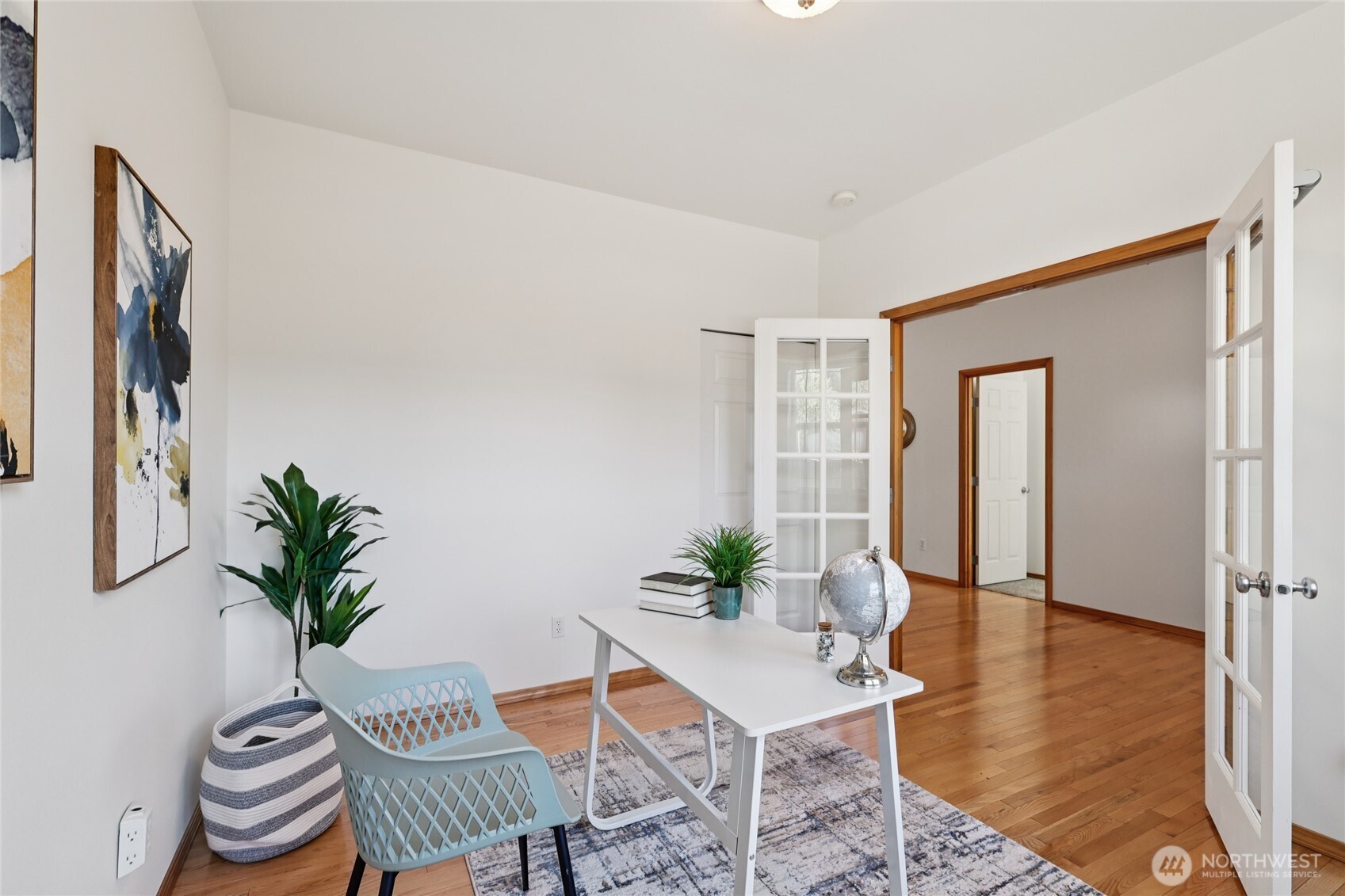 7424 Upper Ridge Road Everett, WA 98203 - Photo 4 of 31 a dining room with furniture potted plants and wooden floor