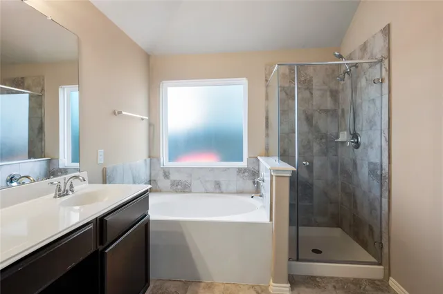 a bathroom with a shower sink and mirror
