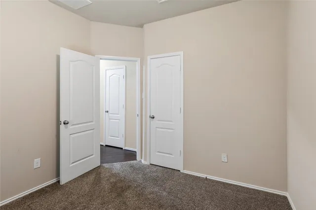 an empty room with closet area