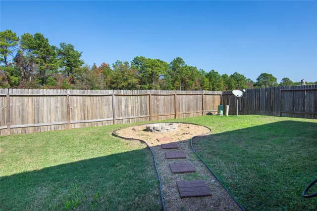 a view of a backyard with a garden and deck