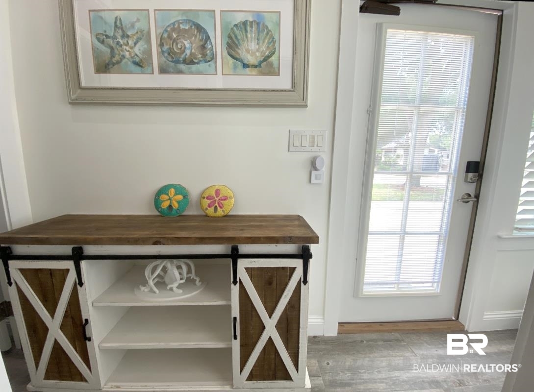 28888 Canal Road, Unit 77 Orange Beach, AL 36561 - Photo 6 of 23 Entryway featuring wood-finish flooring and white baseboards