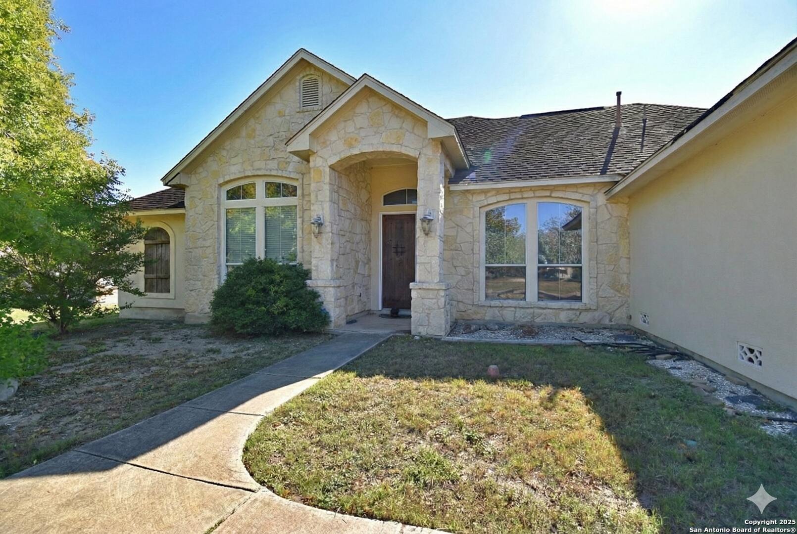 front view of a house with a yard