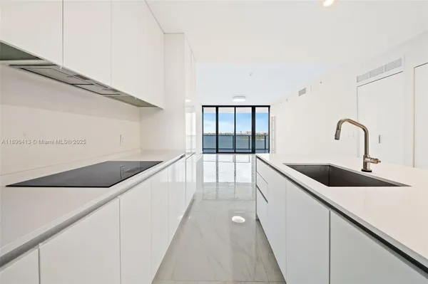 a kitchen with a sink and cabinets