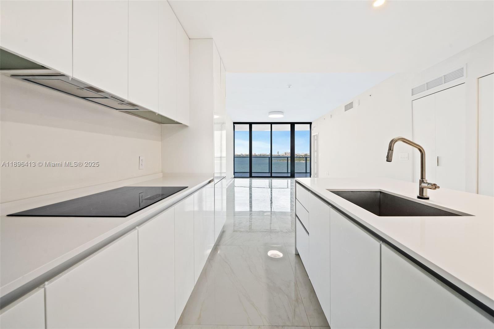 700 Northeast 24th Street, Unit 702 Miami, FL 33137 - Photo 11 of 55 a kitchen with a sink and cabinets
