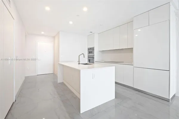 a room with a sink washer and dryer