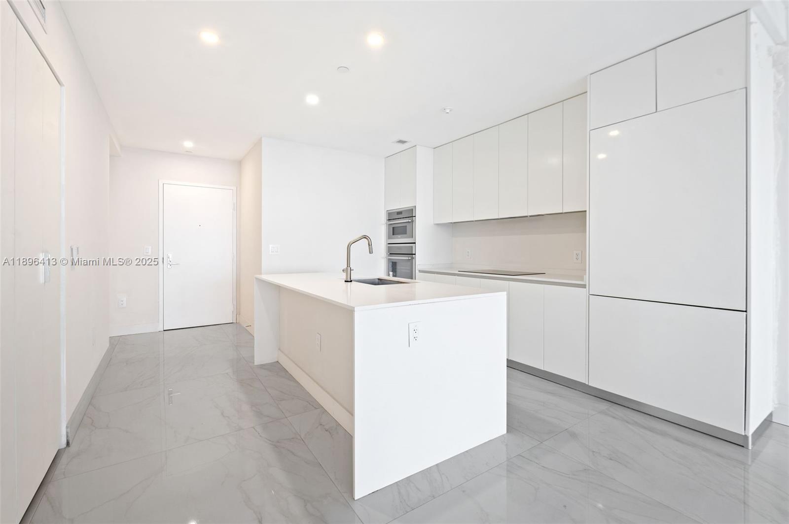 700 Northeast 24th Street, Unit 702 Miami, FL 33137 - Photo 13 of 55 a room with a sink washer and dryer