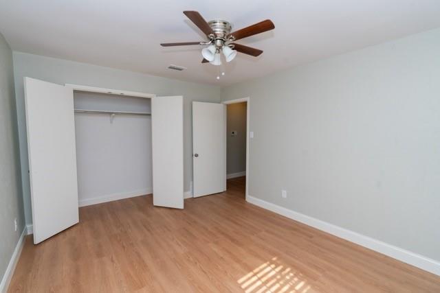 106 Mapleleaf Lane Coppell, TX 75019 - Photo 26 of 36 Spacious room featuring wood-finish flooring, a ceiling fan with light, and light-toned wall paint