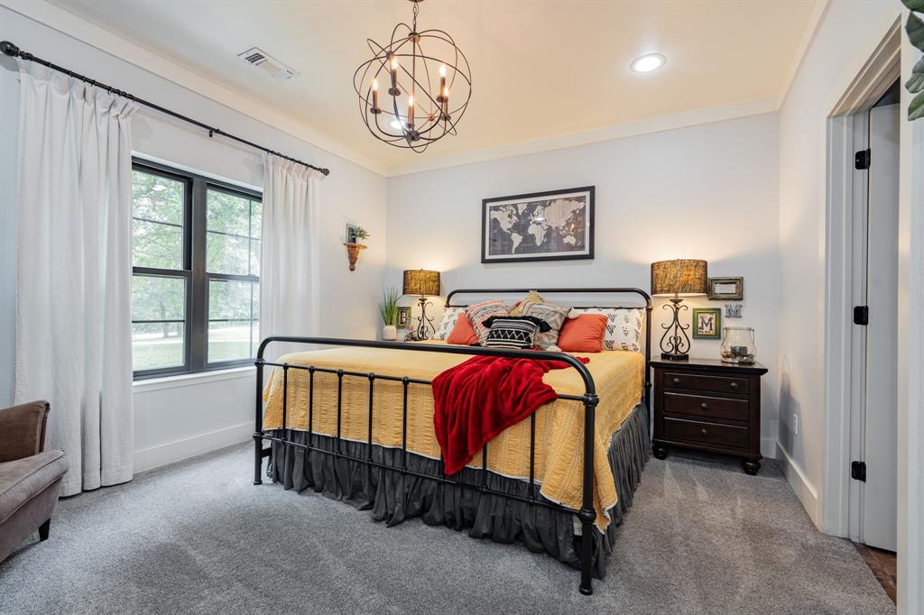 853 County Road 2215 Decatur, TX 76234 - Photo 11 of 39 Primary bedroom with hanging lights and ornamental molding