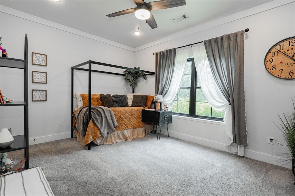 853 County Road 2215 Decatur, TX 76234 - Photo 16 of 39 Bedroom with a ceiling fan, light carpet, crown molding, and recessed lighting