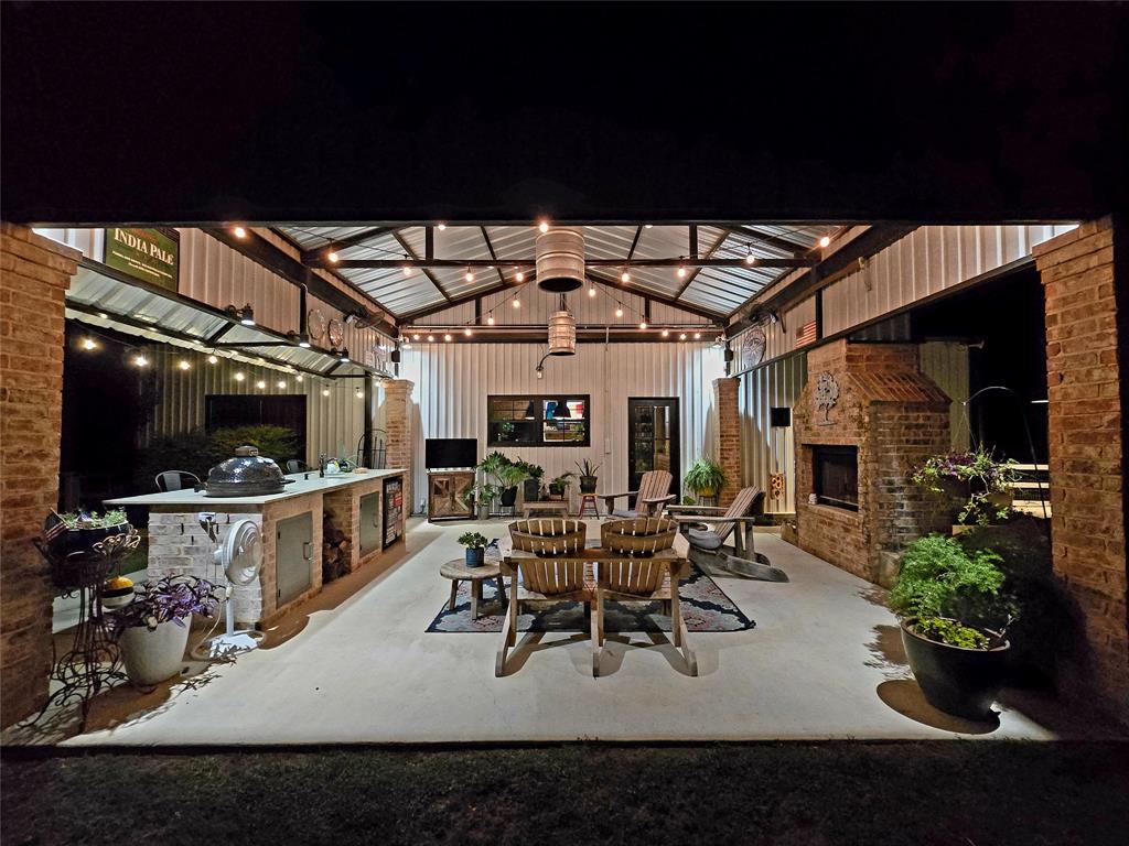 853 County Road 2215 Decatur, TX 76234 - Photo 29 of 39 View of patio / terrace featuring exterior fireplace and an outdoor kitchen / dining area