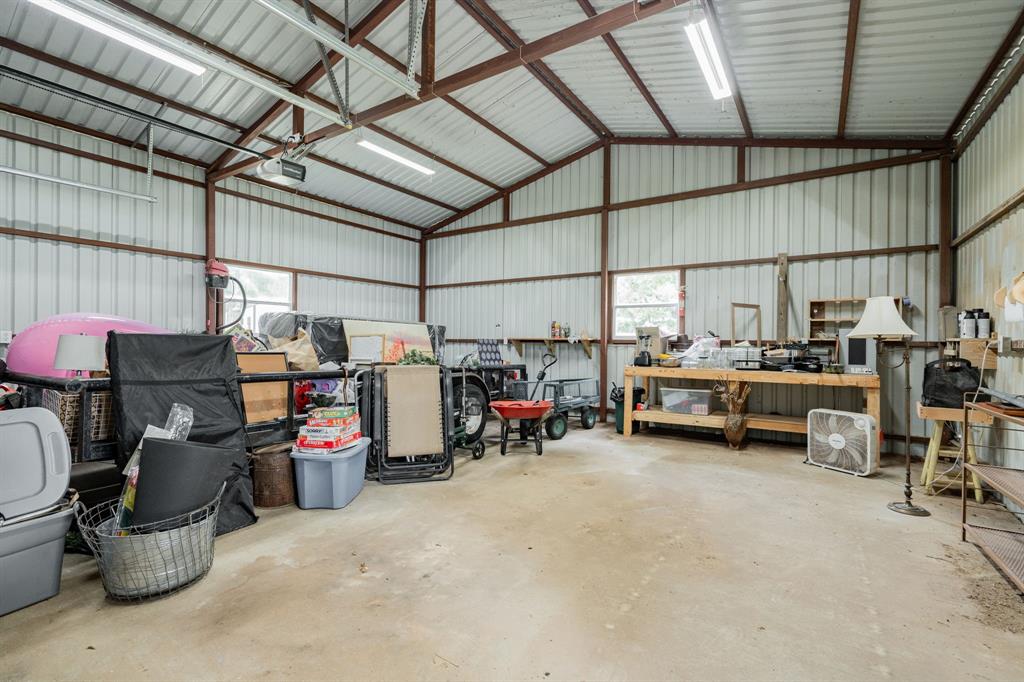 853 County Road 2215 Decatur, TX 76234 - Photo 36 of 39 Guest house garage featuring a workshop area and metal wall