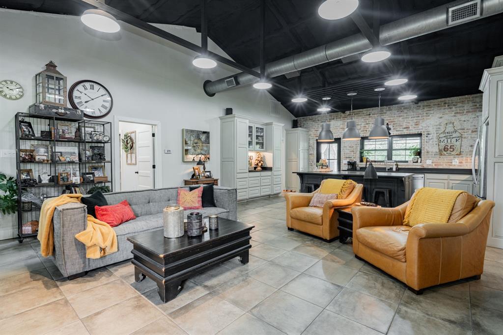853 County Road 2215 Decatur, TX 76234 - Photo 6 of 39 Living room with brick wall and a high ceiling