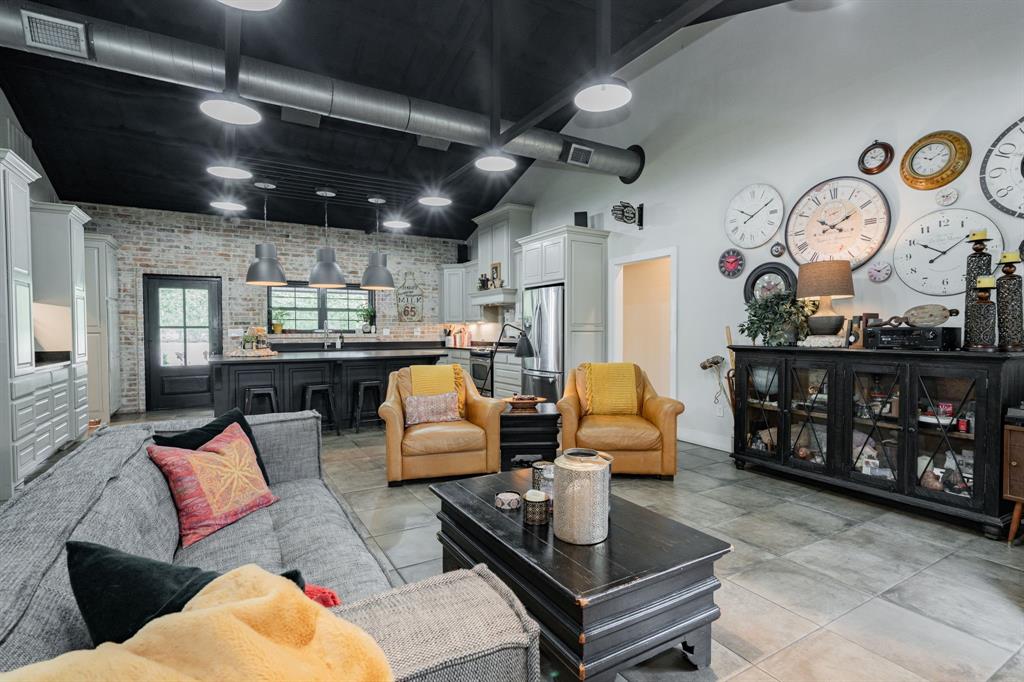 853 County Road 2215 Decatur, TX 76234 - Photo 8 of 39 Living area featuring brick wall and a high ceiling