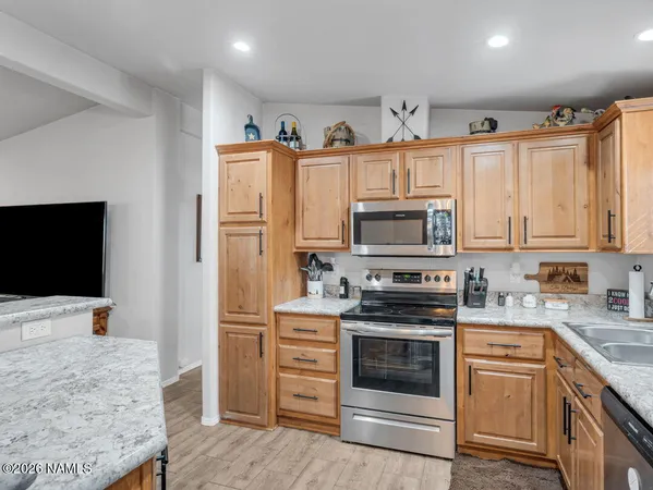 a kitchen with stainless steel appliances granite countertop a stove and a refrigerator