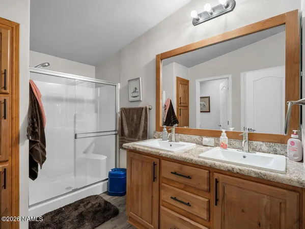 a bathroom with a sink double vanity and a mirror