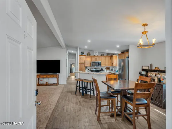 a view of a dining room with furniture and a flat screen tv