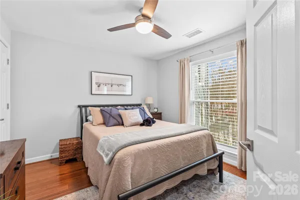 a bedroom with a large bed and a window