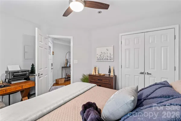 a bedroom with a bed and a chandelier