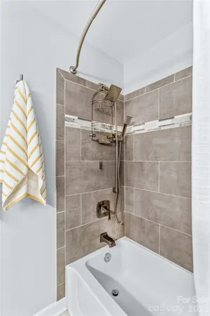 a bathroom with a bathtub and a shower