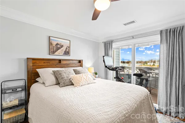 a bedroom with a large bed and a large window