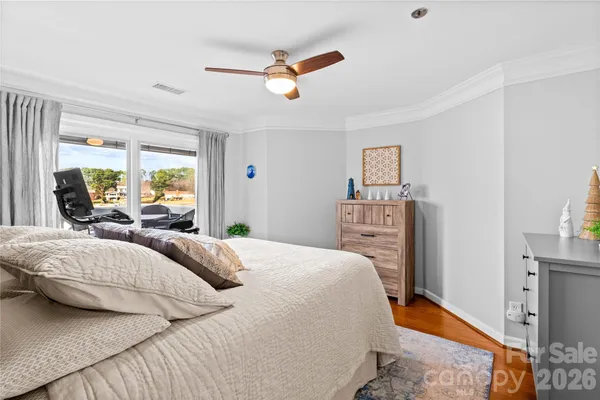 a bedroom with a large bed and a chandelier