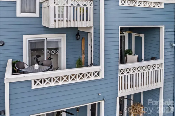 a view of a chairs and table in the balcony
