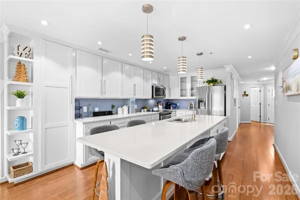 a large kitchen with a table and chairs