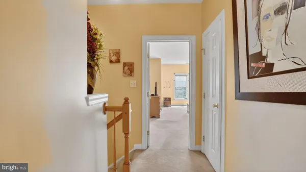 a bed sitting in a spacious bedroom next to a window